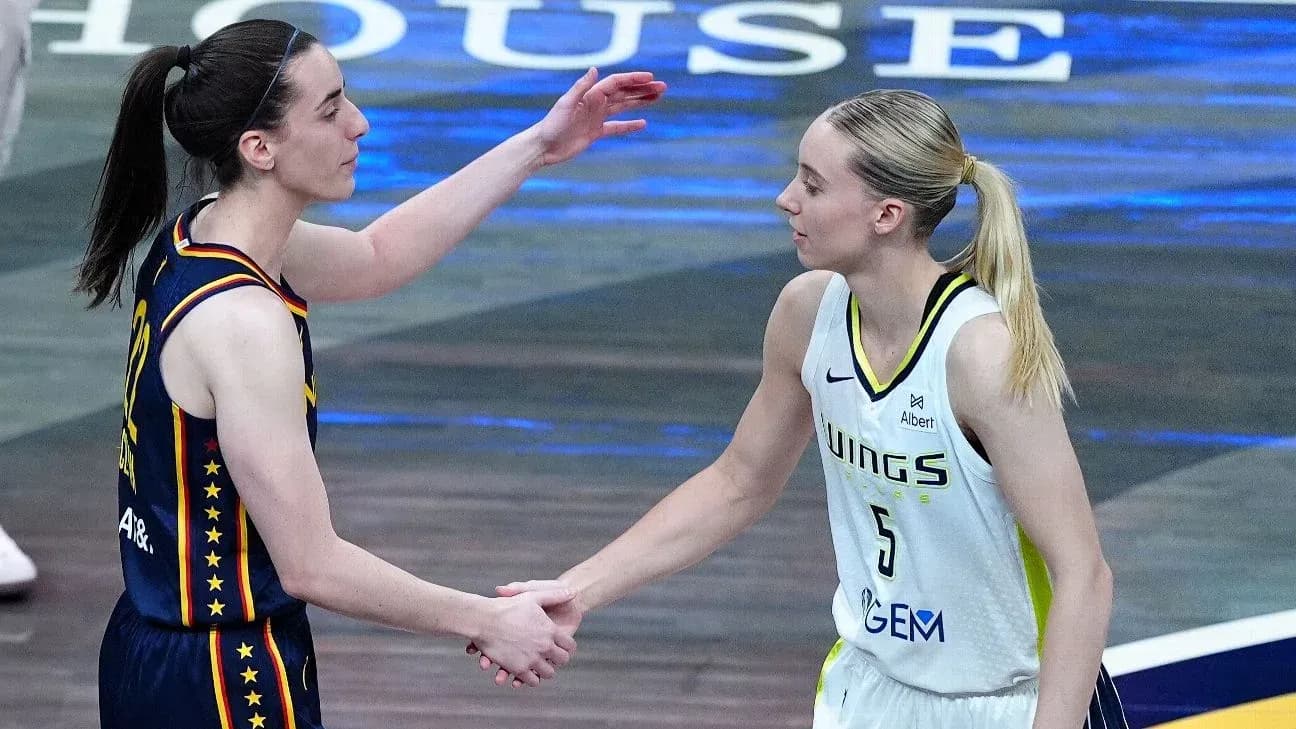 Two basketball players shaking hands after the game Two basketball players shaking hands after the game