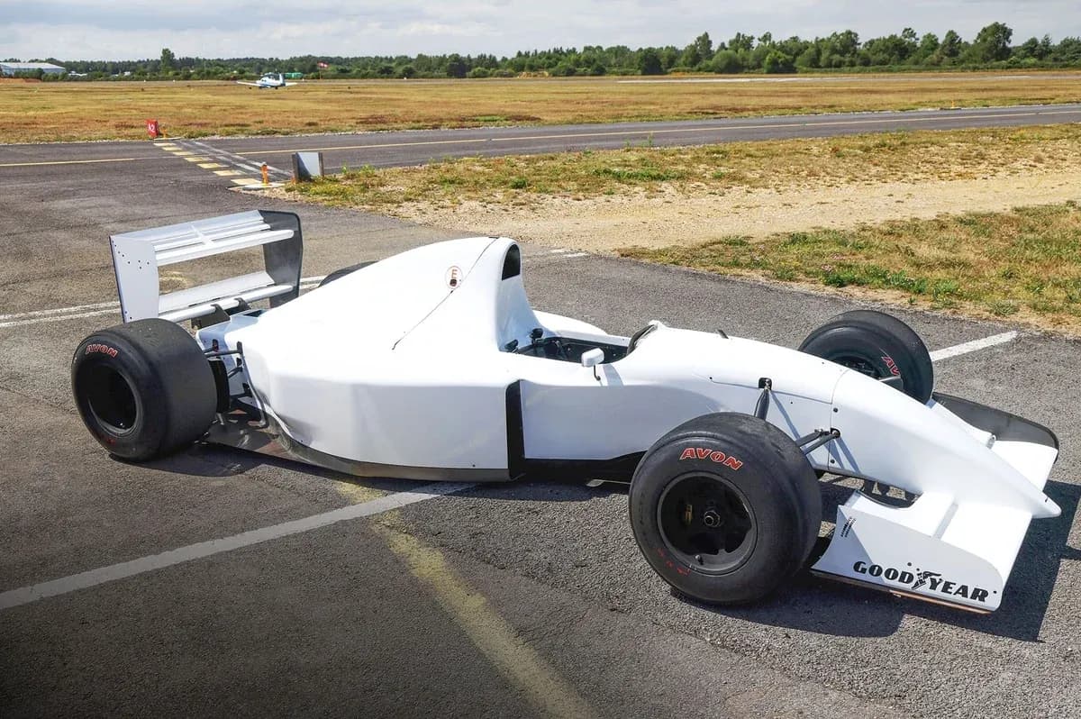 White race car parked on the tarmac White race car parked on the tarmac