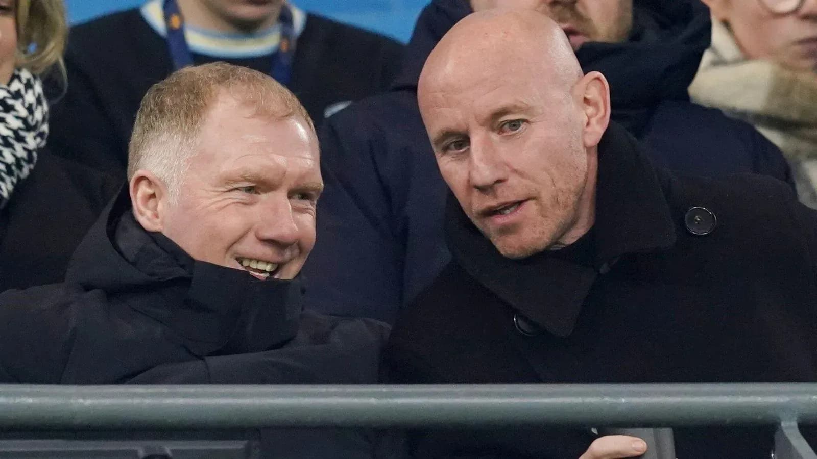 Two men talking in the stands at a match Two men talking in the stands at a match