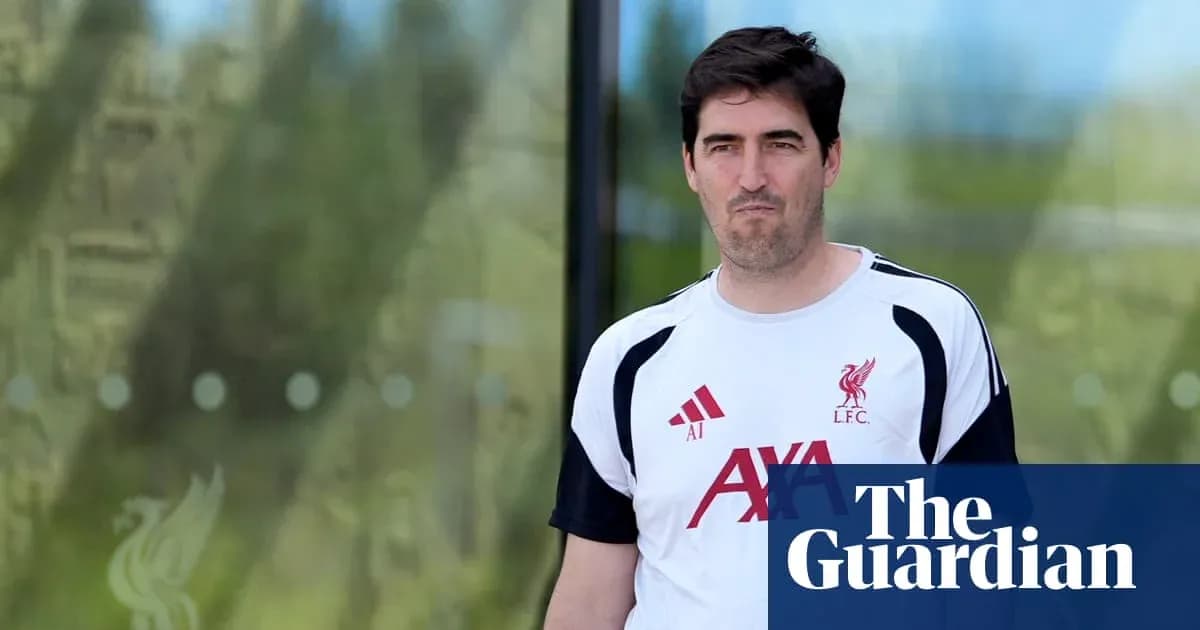 Man in Liverpool FC training kit walking outside Man in Liverpool FC training kit walking outside