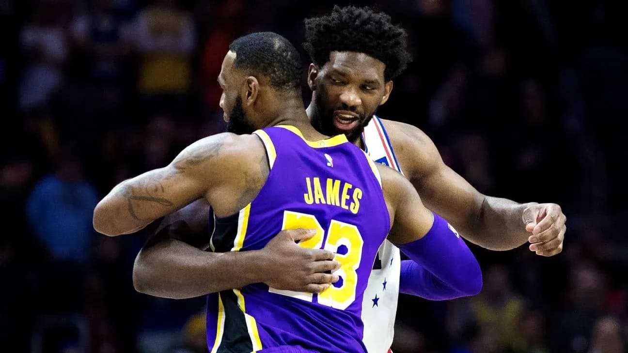 LeBron James and Joel Embiid embracing on court LeBron James and Joel Embiid embracing on court