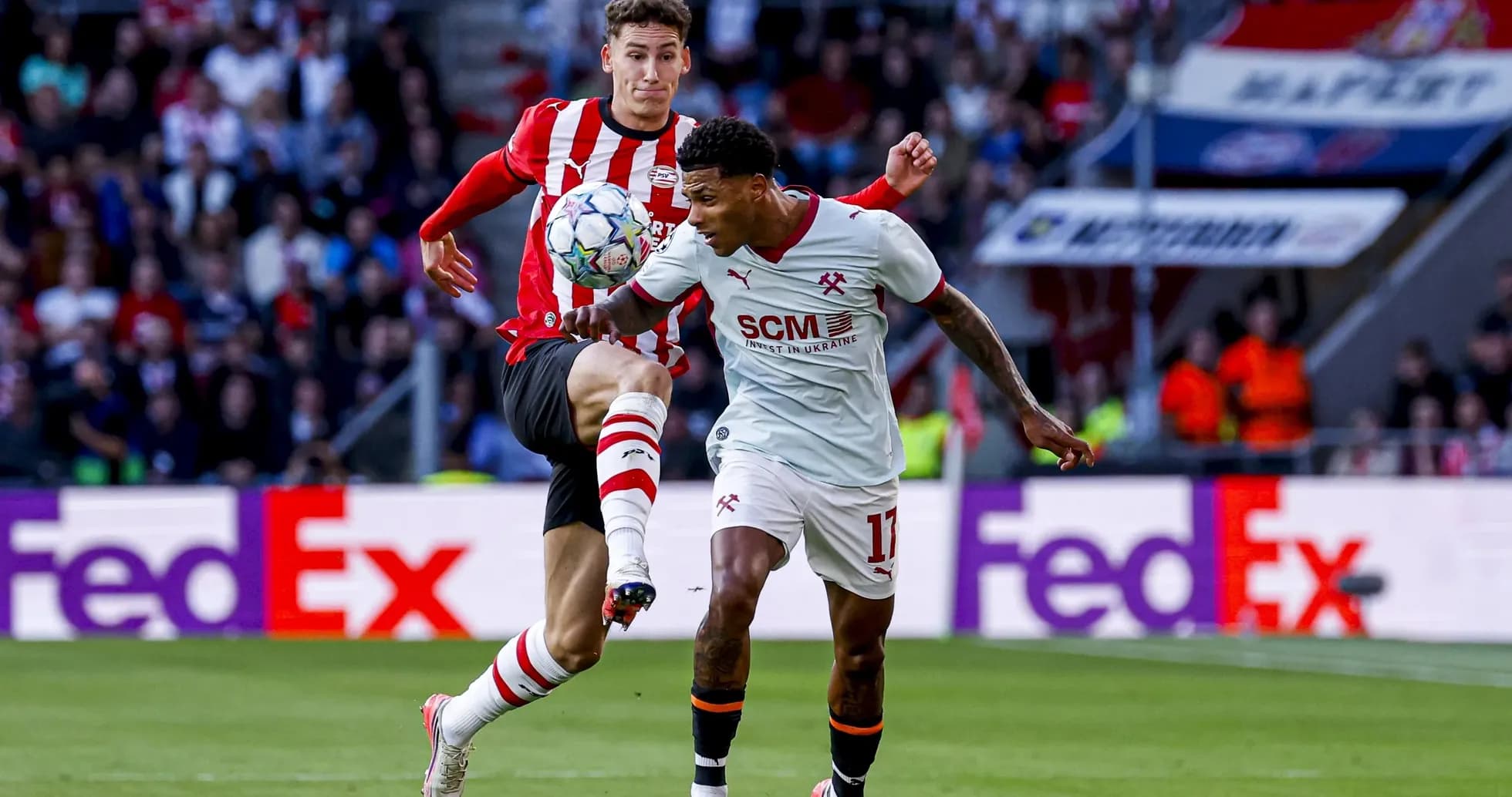 Two players contesting the ball during a match Two players contesting the ball during a match