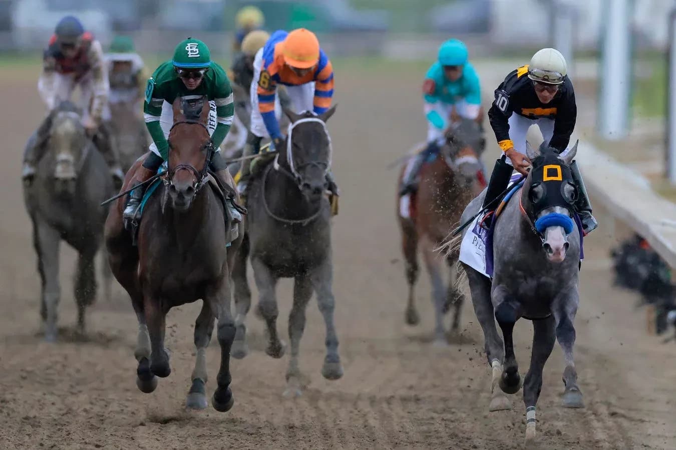 Horses racing on dirt track during competition Horses racing on dirt track during competition