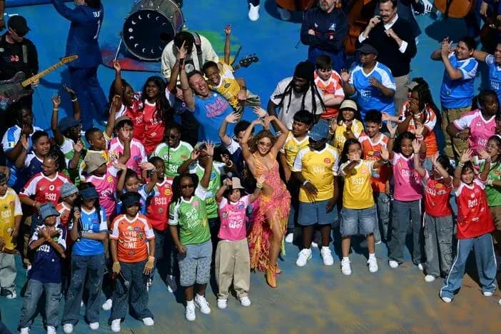 J Lo with children performing at an event J Lo with children performing at an event