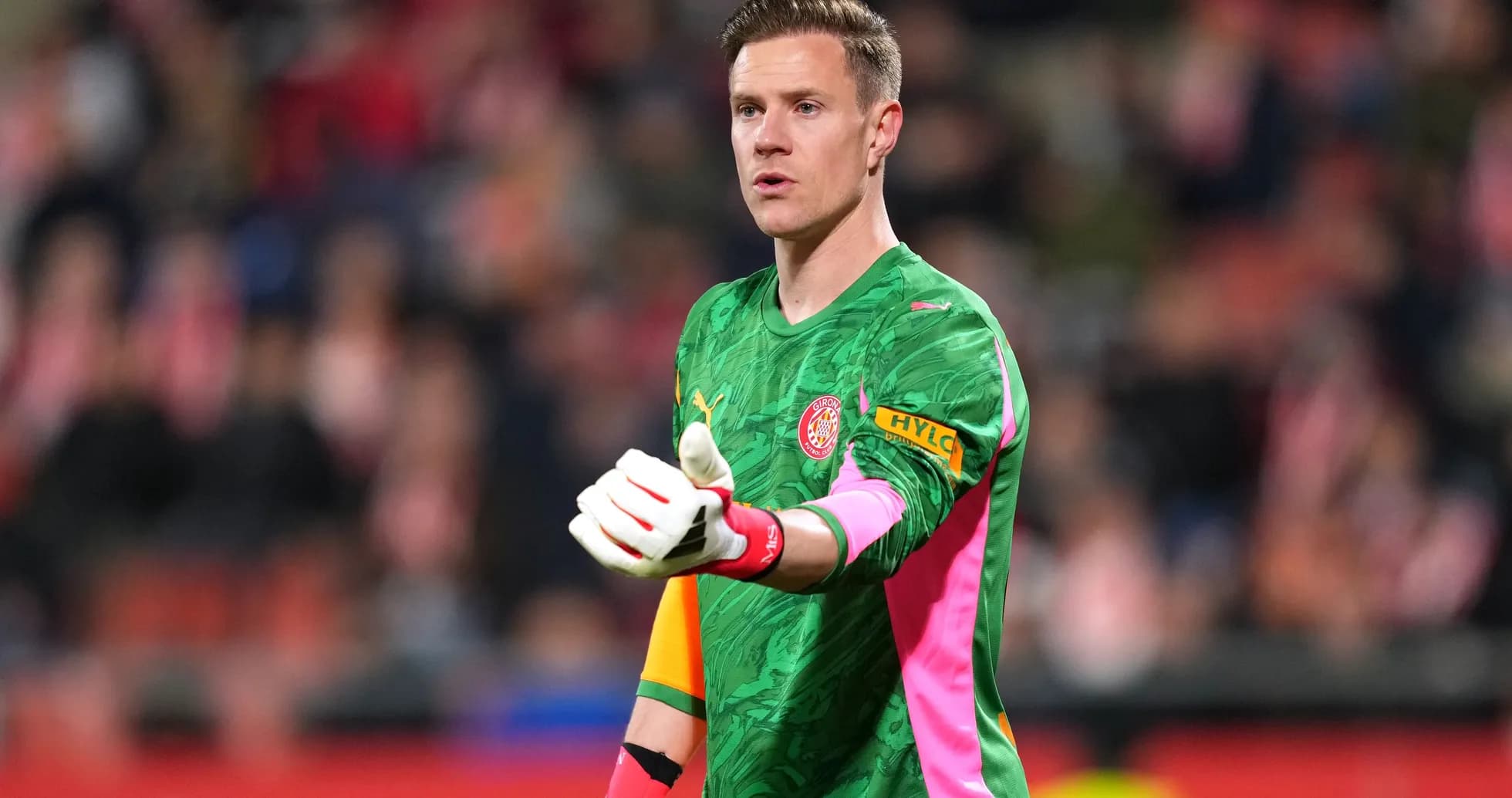 Goalkeeper gesturing during match in colorful kit Goalkeeper gesturing during match in colorful kit