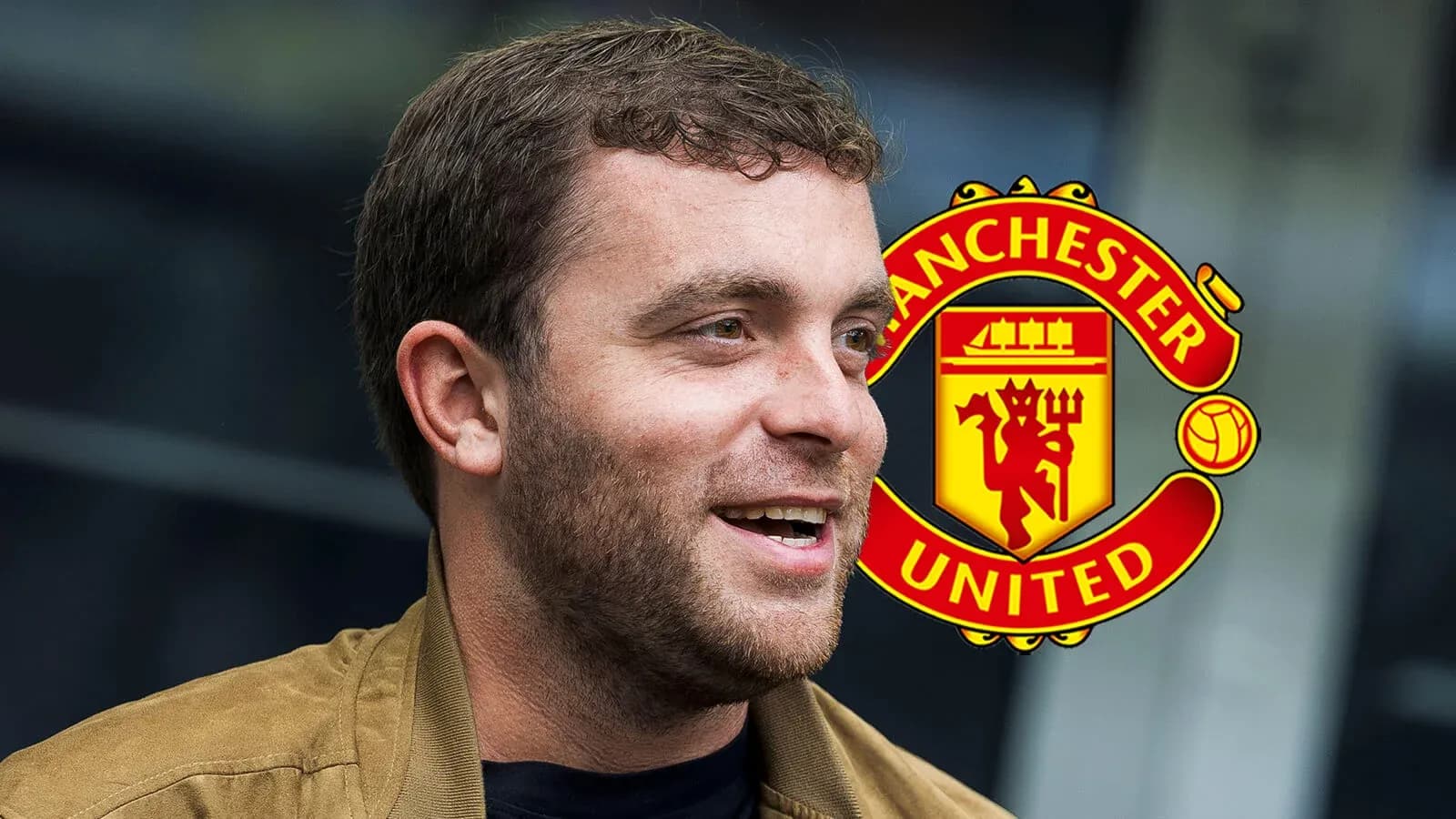 Shirted man smiling with Manchester United logo background Shirted man smiling with Manchester United logo background