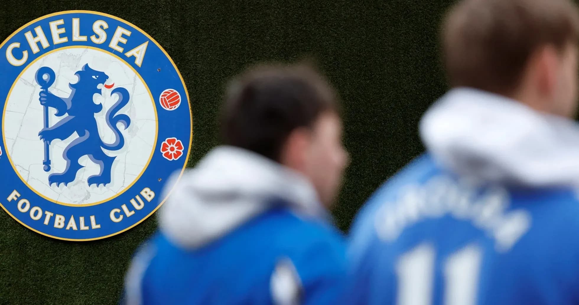 Chelsea FC logo with players in blue jerseys Chelsea FC logo with players in blue jerseys