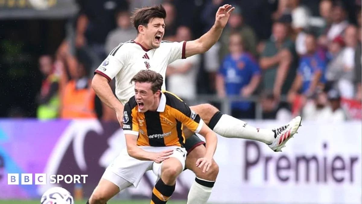Two players colliding during a football match Two players colliding during a football match