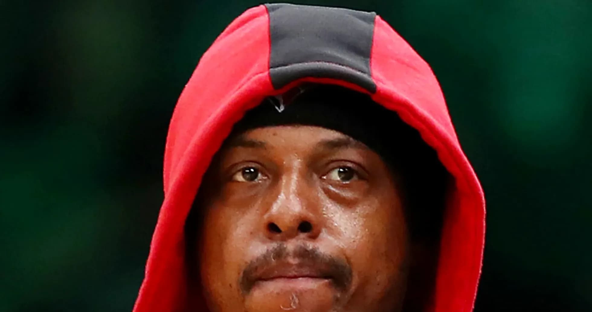 Basketball player wearing red hoodie, focused expression Basketball player wearing red hoodie, focused expression