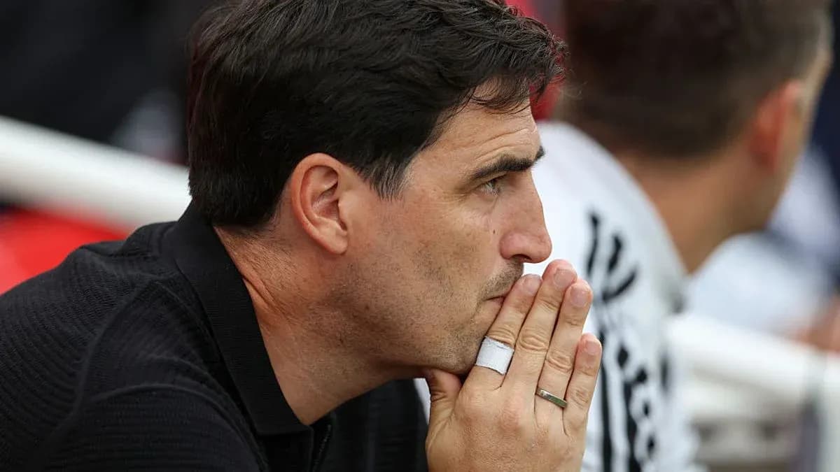 Coach deep in thought during match on sidelines Coach deep in thought during match on sidelines