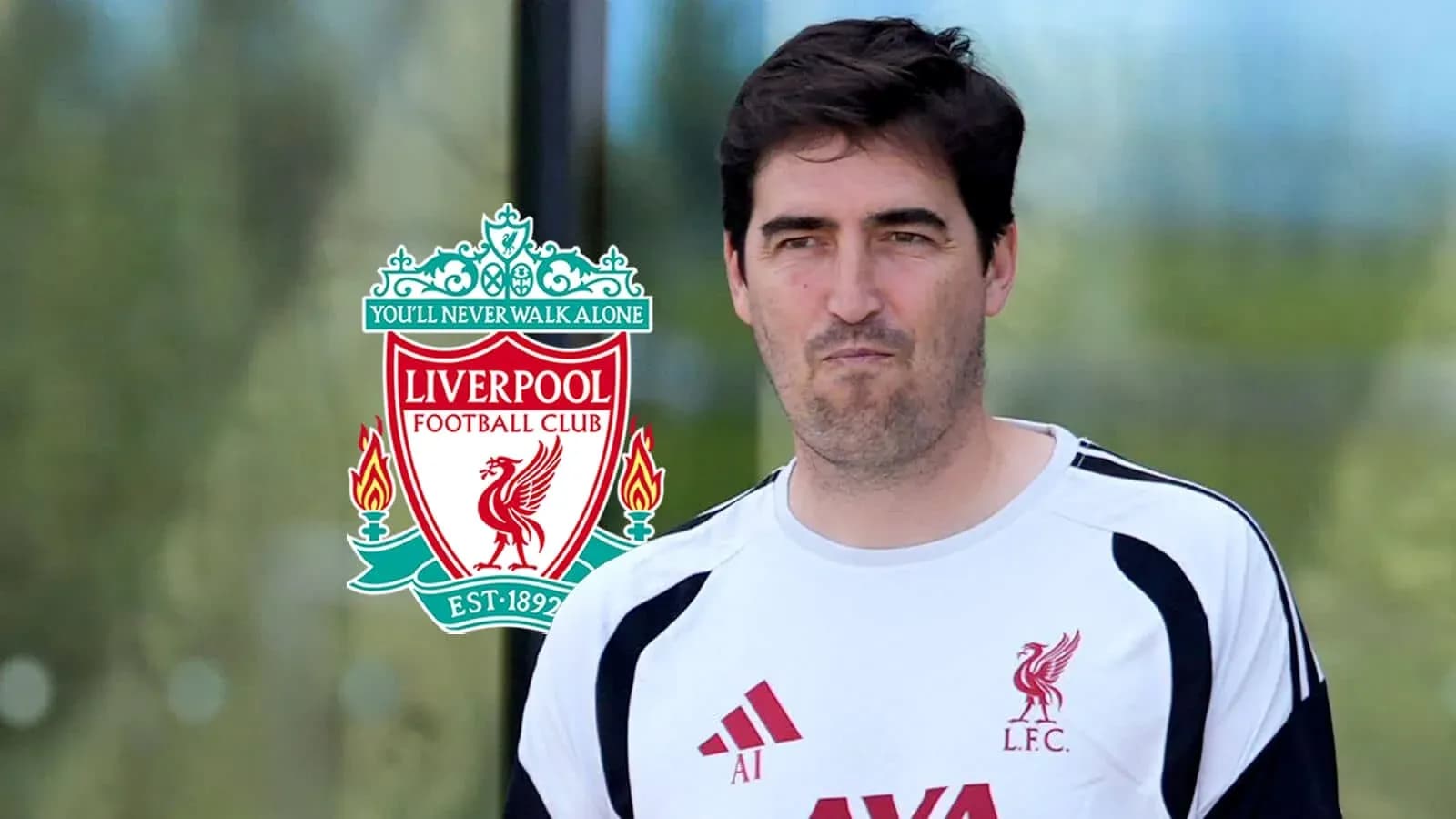 Person in Liverpool FC training kit near club logo Person in Liverpool FC training kit near club logo