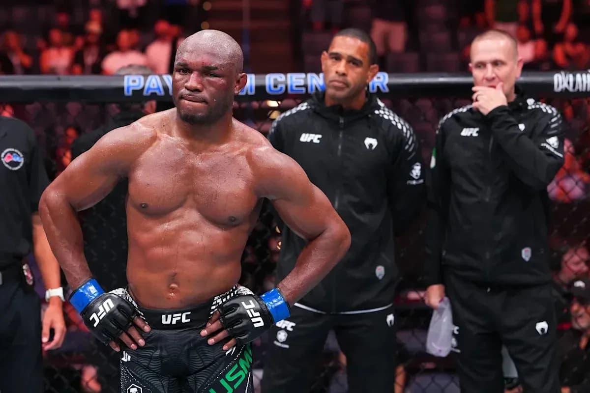 MMA fighter in octagon with coaches behind MMA fighter in octagon with coaches behind