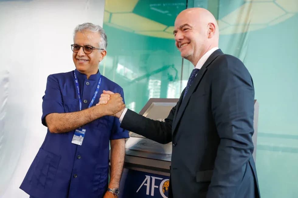 Two officials shaking hands at AFC event Two officials shaking hands at AFC event
