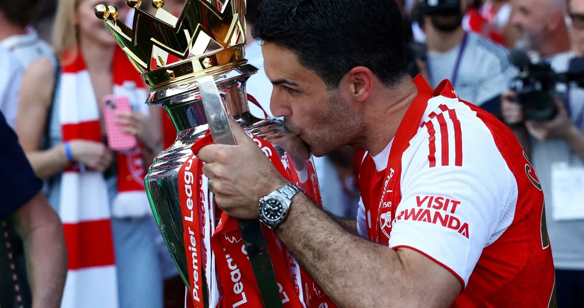 Mikel Arteta kissing Premier League trophy in celebration Mikel Arteta kissing Premier League trophy in celebration