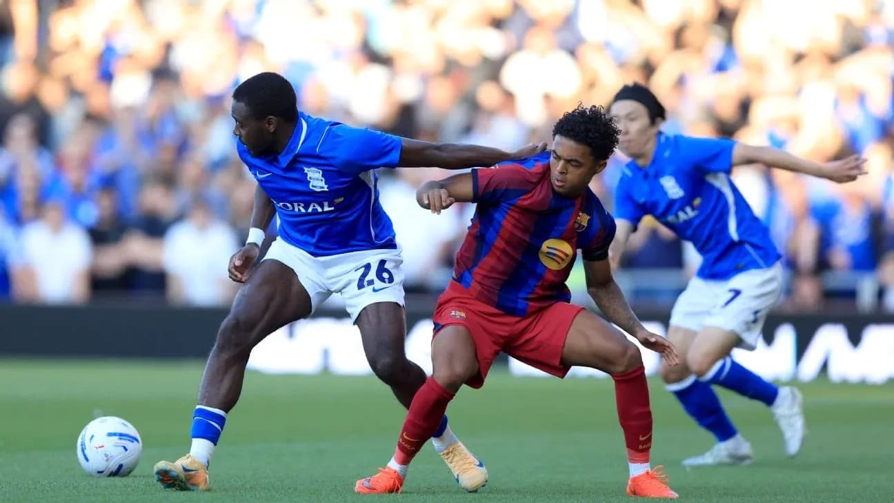 Birmingham City and Barcelona players battling for possession Birmingham City and Barcelona players battling for possession
