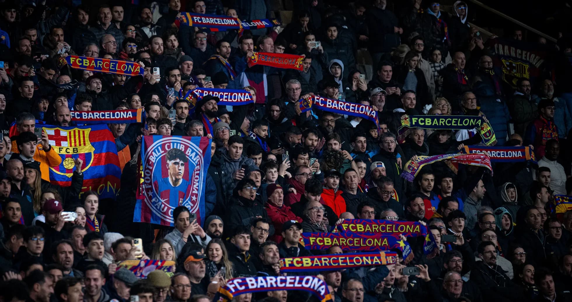 FC Barcelona fans cheering with scarves in stadium FC Barcelona fans cheering with scarves in stadium