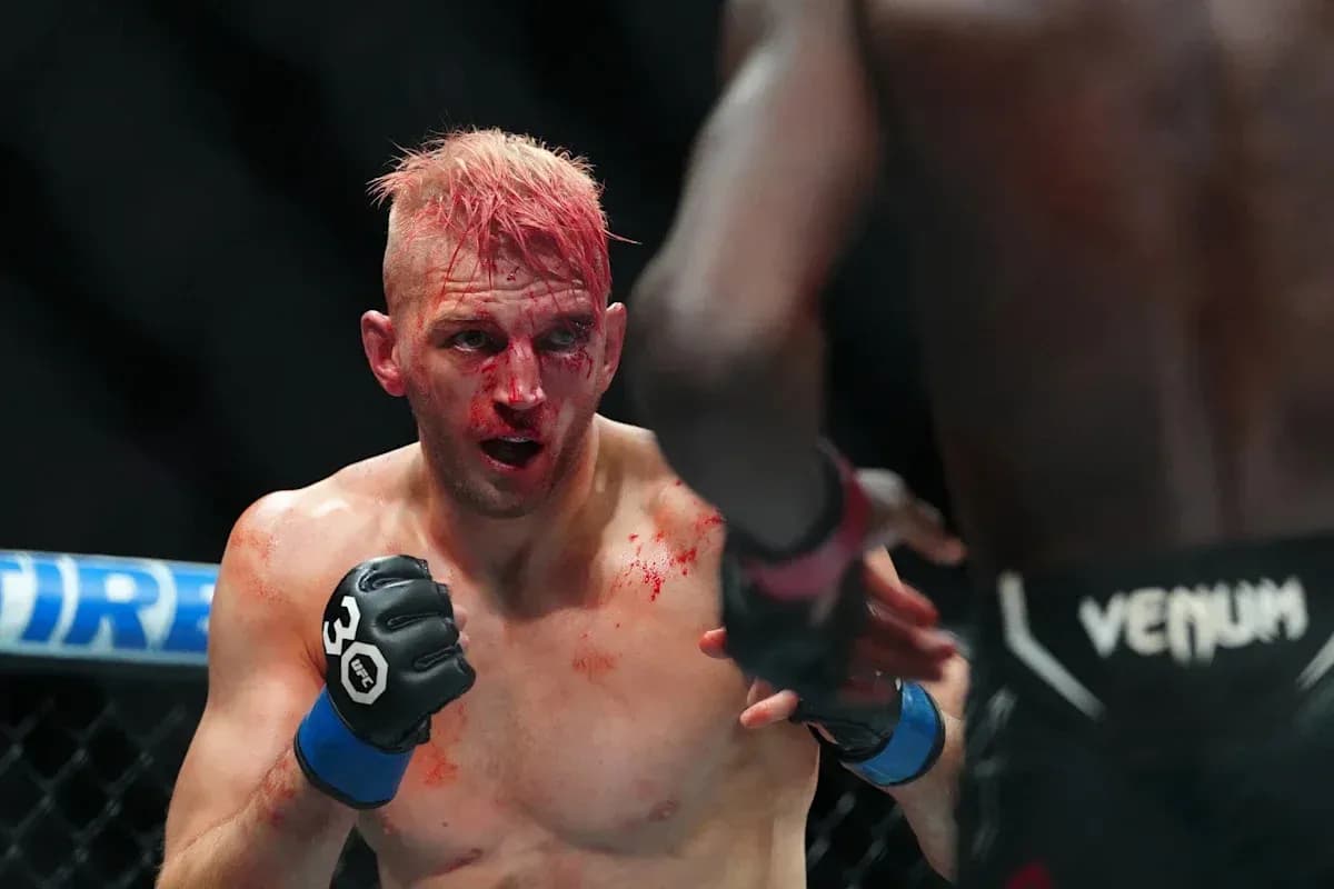 MMA fighter with blood on face in ring MMA fighter with blood on face in ring