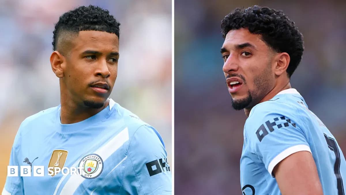 Two Manchester City players in match jerseys Two Manchester City players in match jerseys