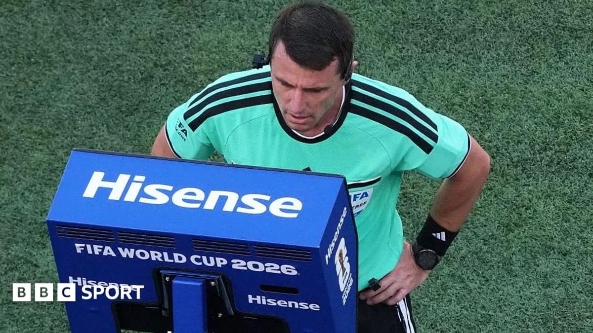Referee reviewing a decision on VAR monitor Referee reviewing a decision on VAR monitor