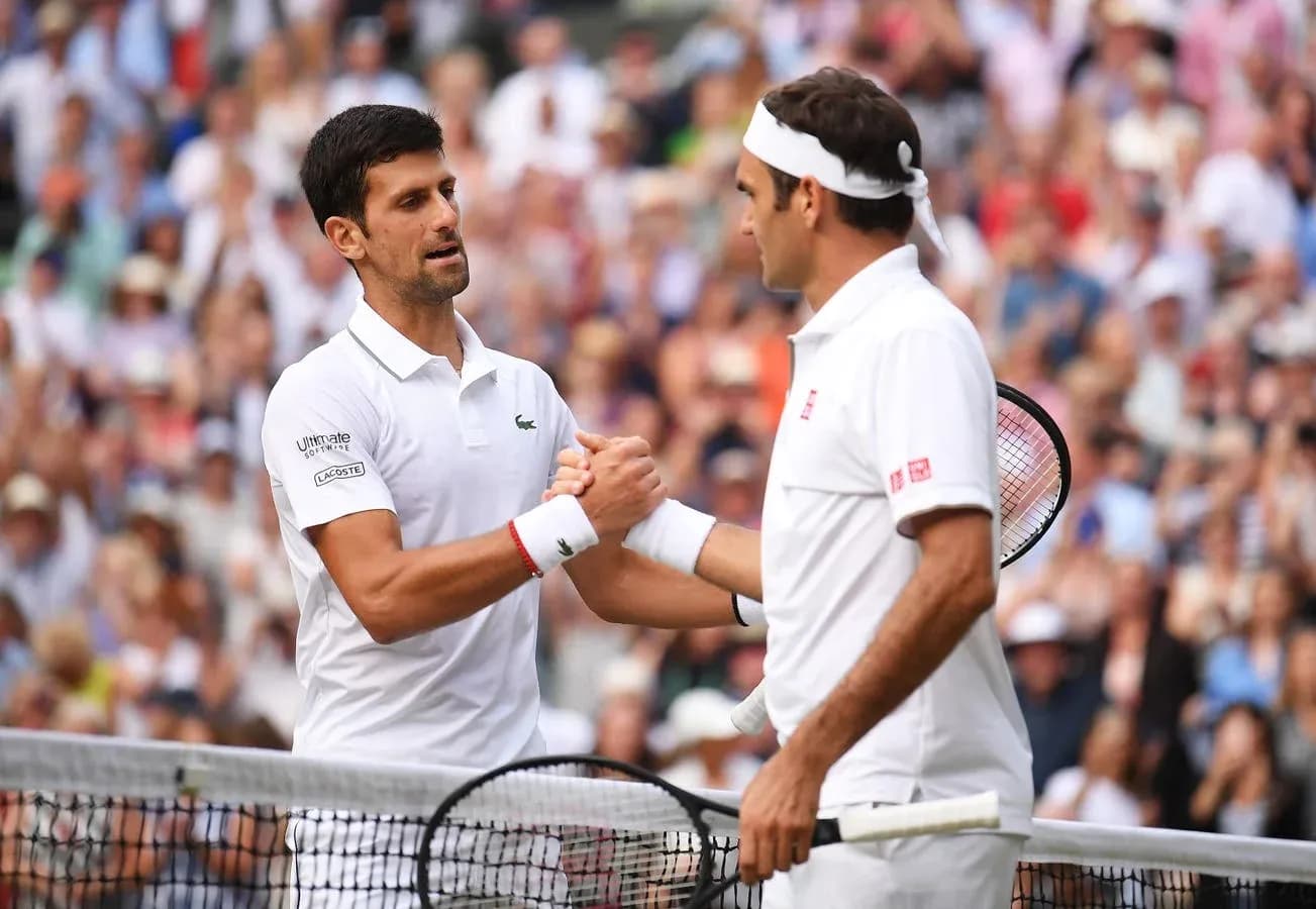 Novak Djokovic and Roger Federer shaking hands at Wimbledon Novak Djokovic and Roger Federer shaking hands at Wimbledon