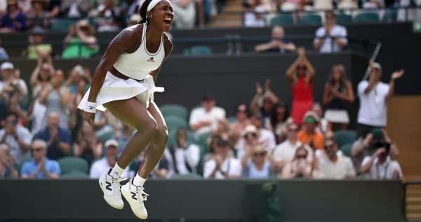 Tennis player celebrating in front of cheering crowd Tennis player celebrating in front of cheering crowd
