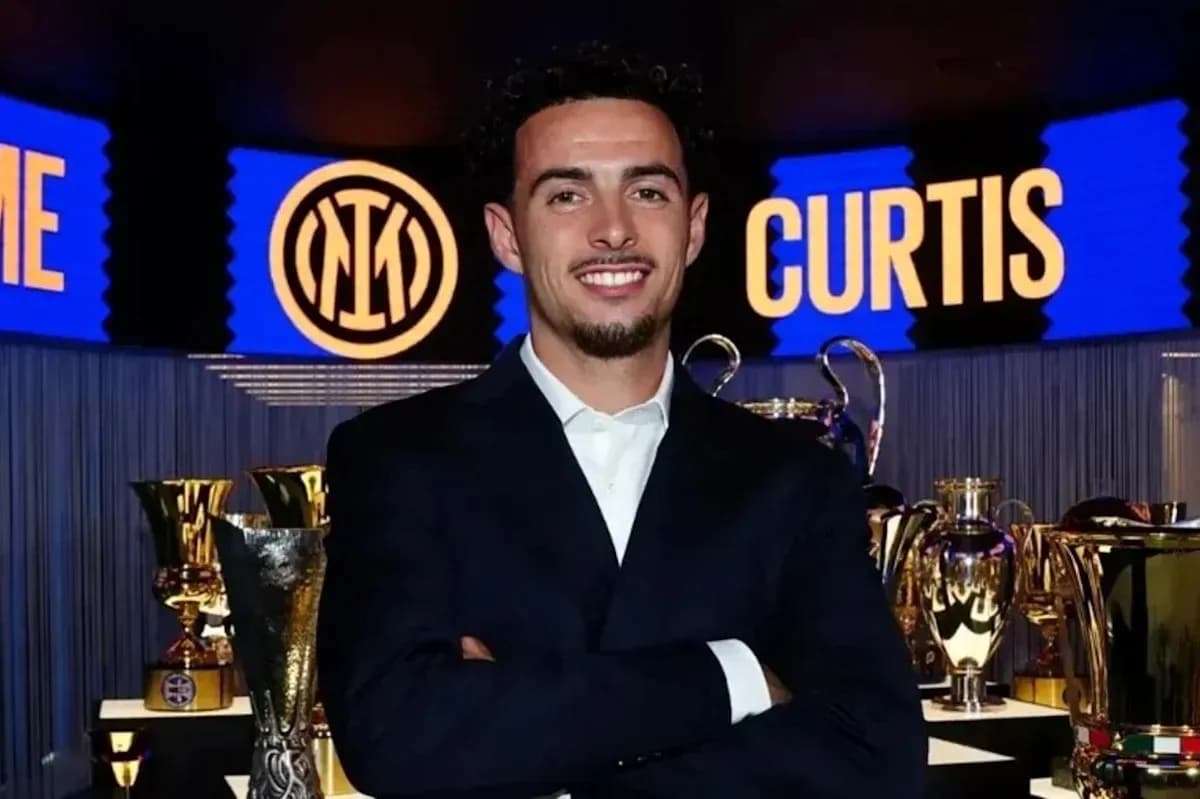 Young man in suit with trophies in background Young man in suit with trophies in background