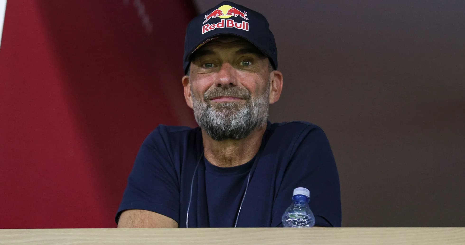 Man in Red Bull cap observing from a balcony Man in Red Bull cap observing from a balcony
