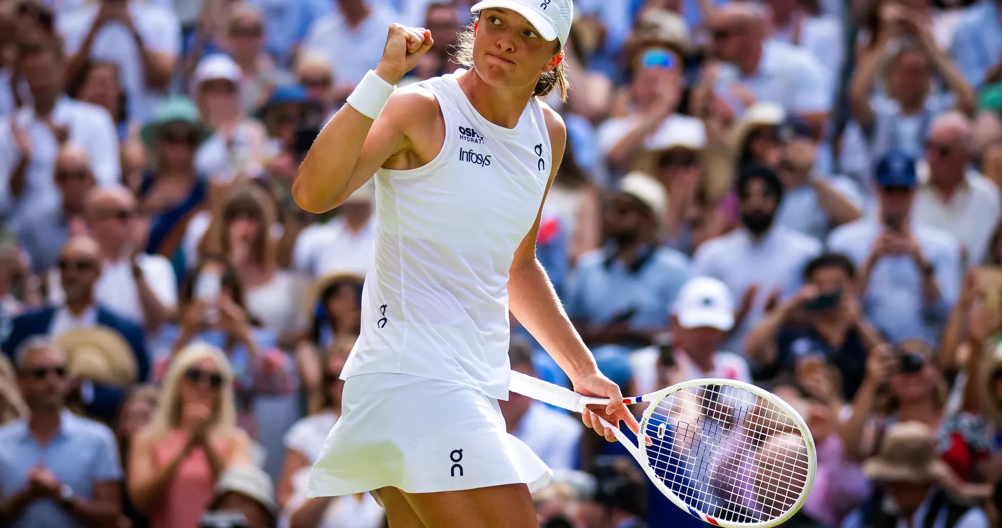 Tennis player celebrating in front of cheering crowd Tennis player celebrating in front of cheering crowd