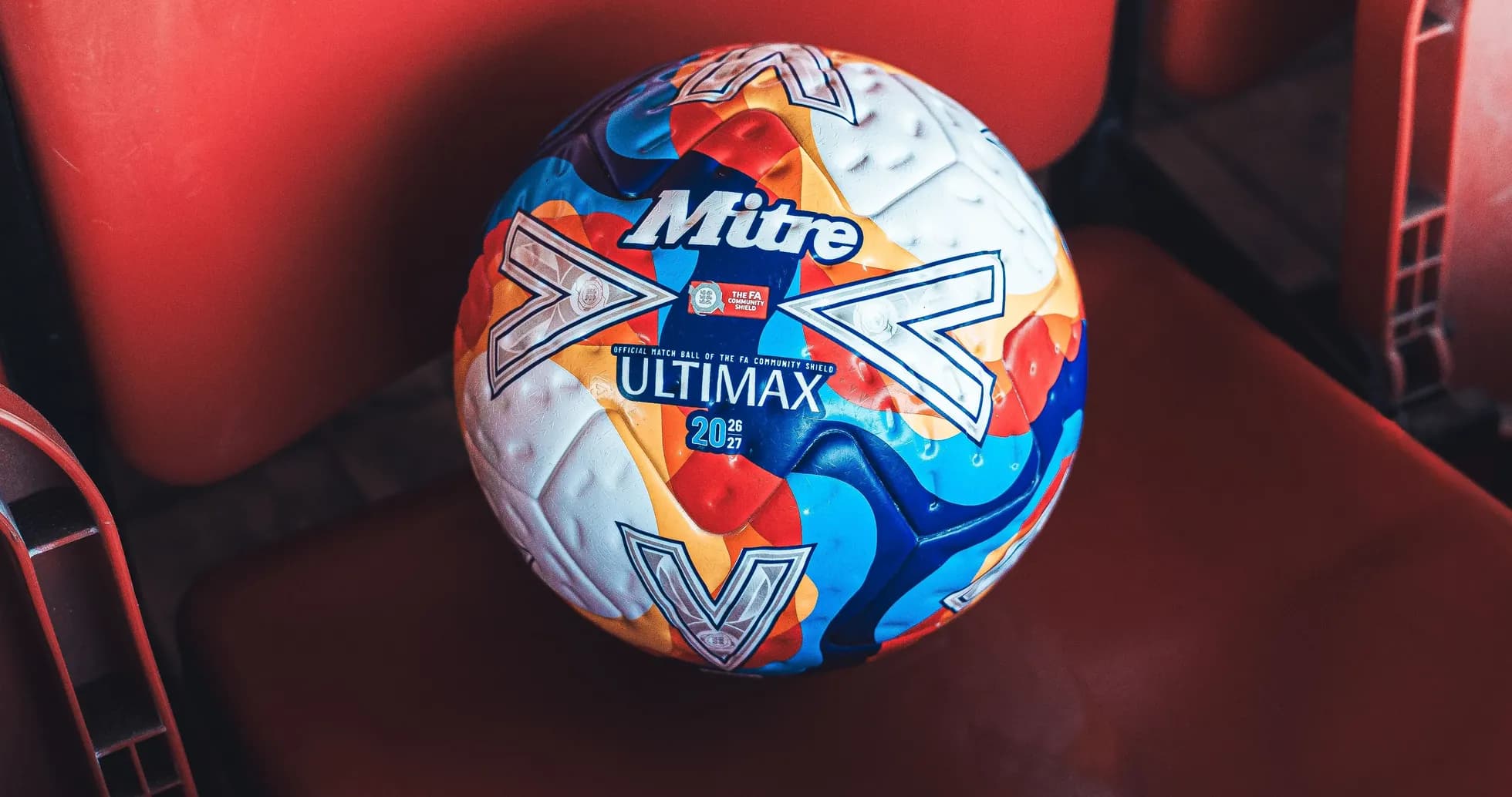 Mitre Ultimax football resting on stadium seat Mitre Ultimax football resting on stadium seat