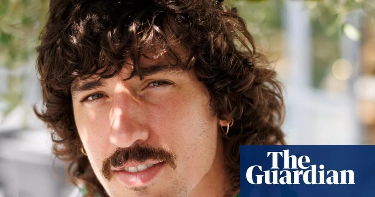 Young man with curly hair and mustache Young man with curly hair and mustache
