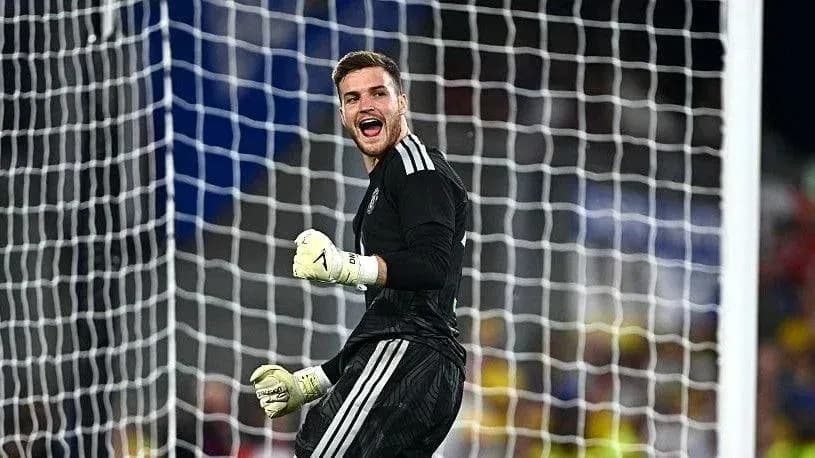 Goalkeeper celebrating a save in front of the net Goalkeeper celebrating a save in front of the net