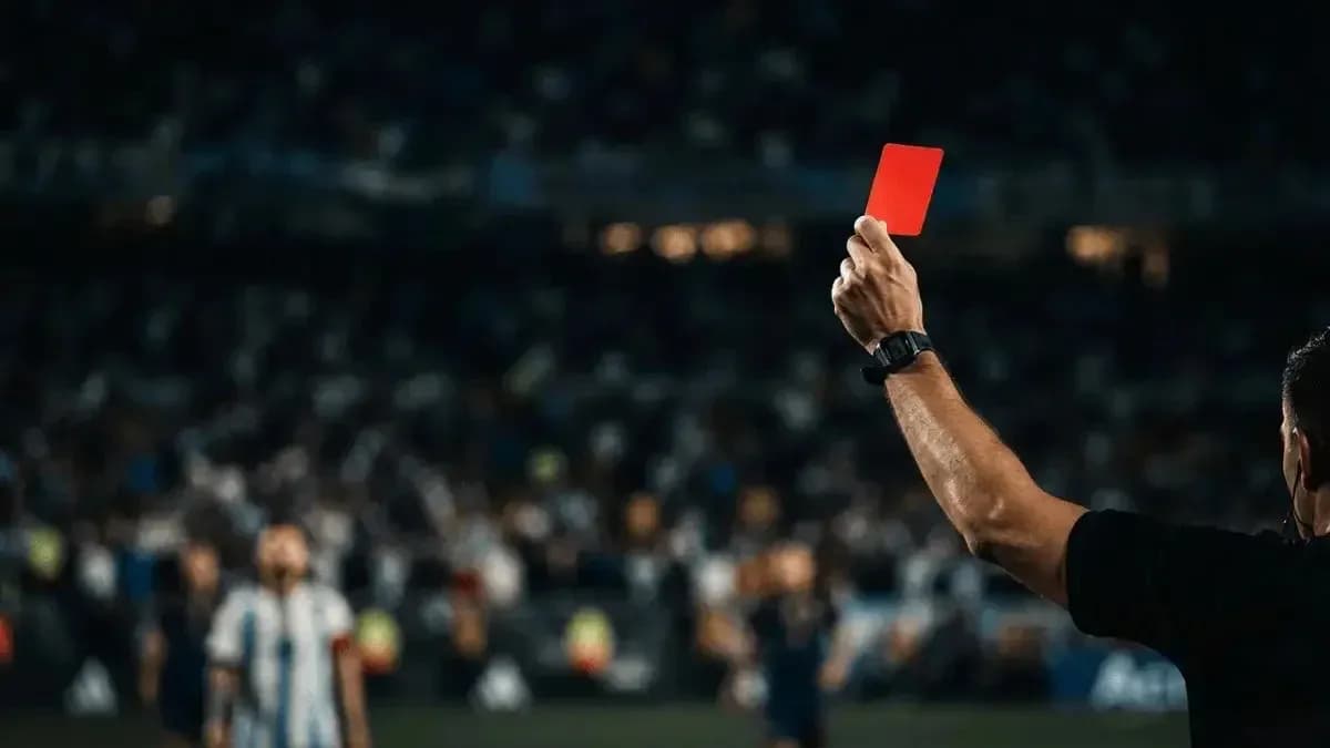 Referee showing red card to player during match Referee showing red card to player during match