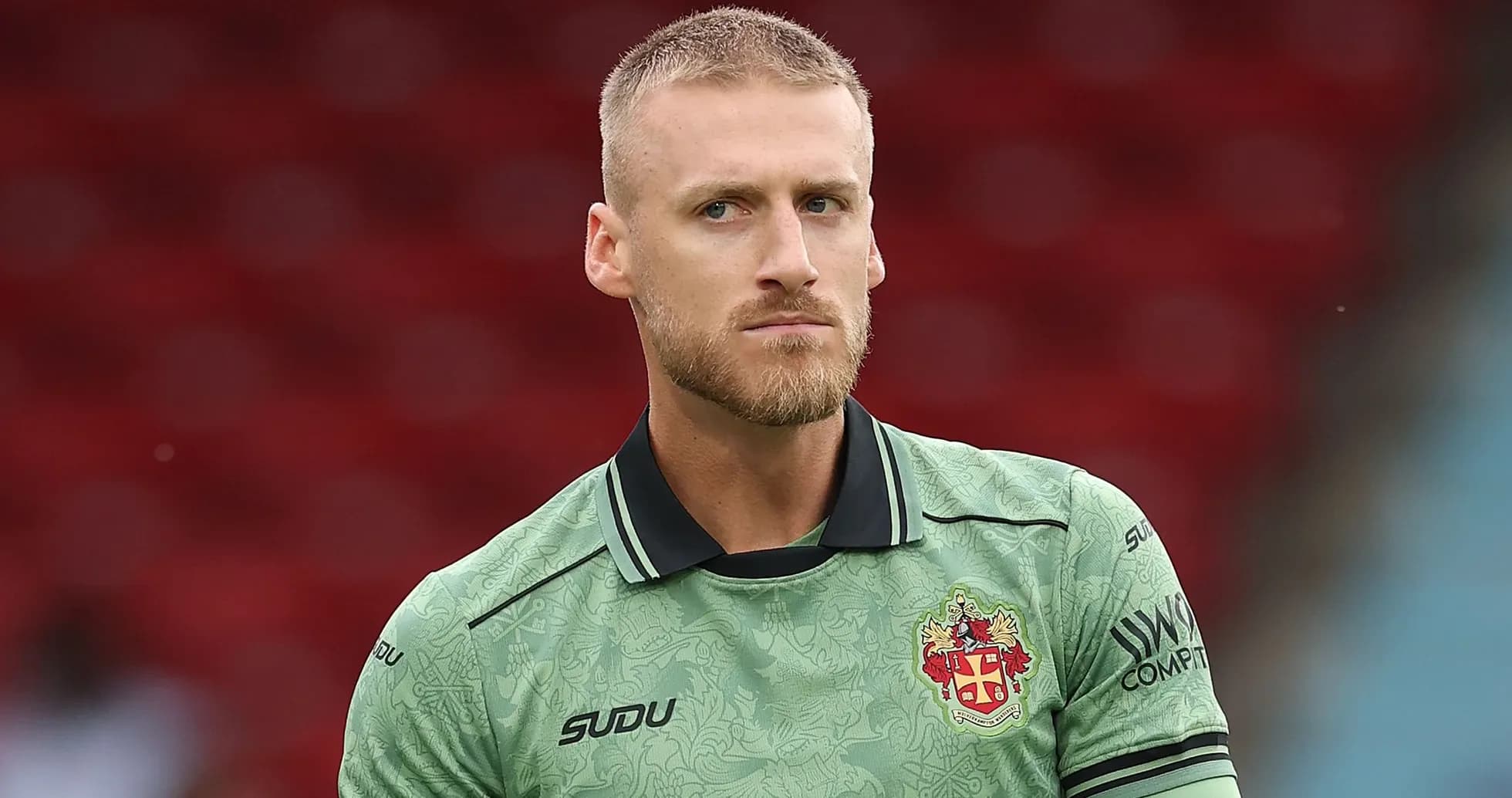 Goalkeeper wearing green kit during match preparation Goalkeeper wearing green kit during match preparation