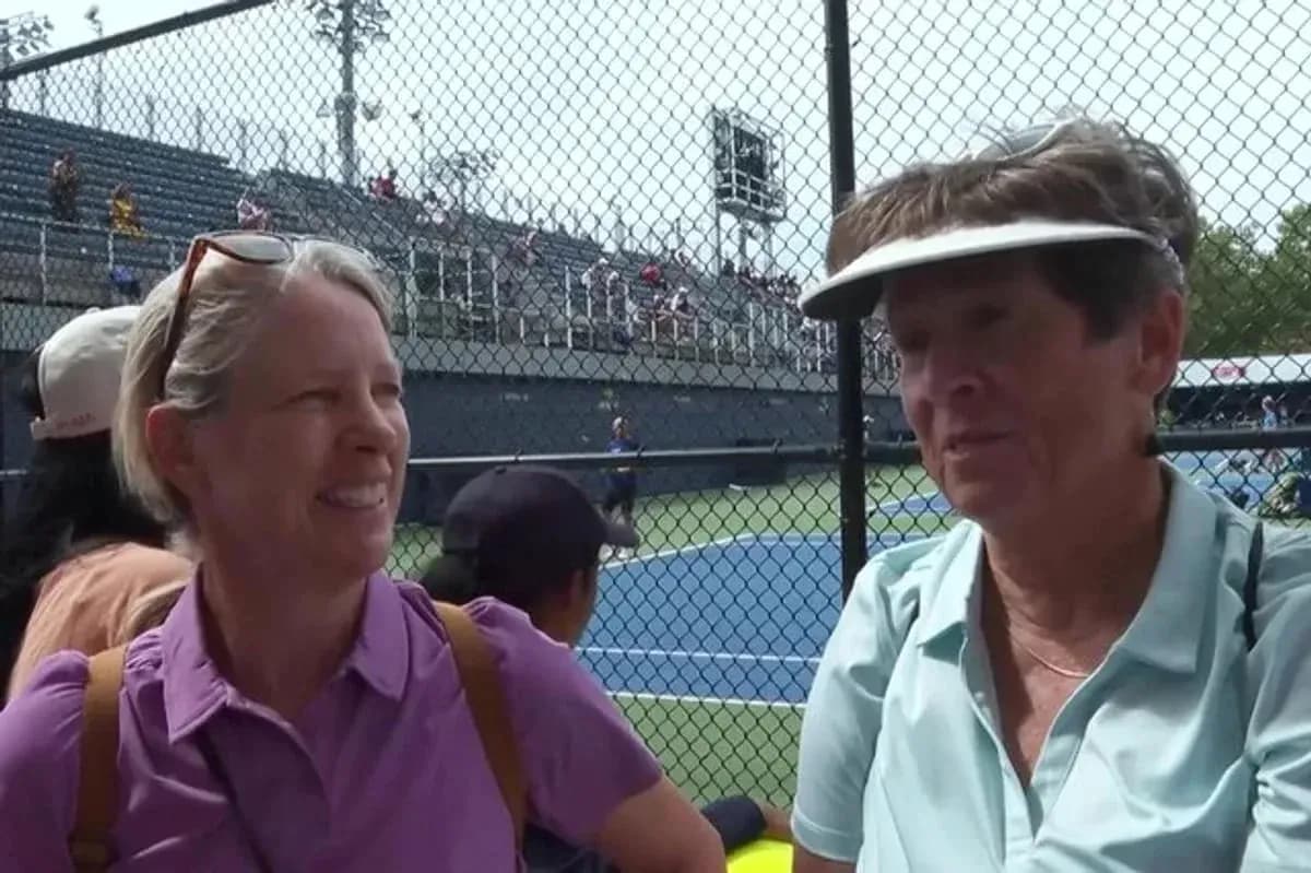 Two women talking at a tennis match Two women talking at a tennis match