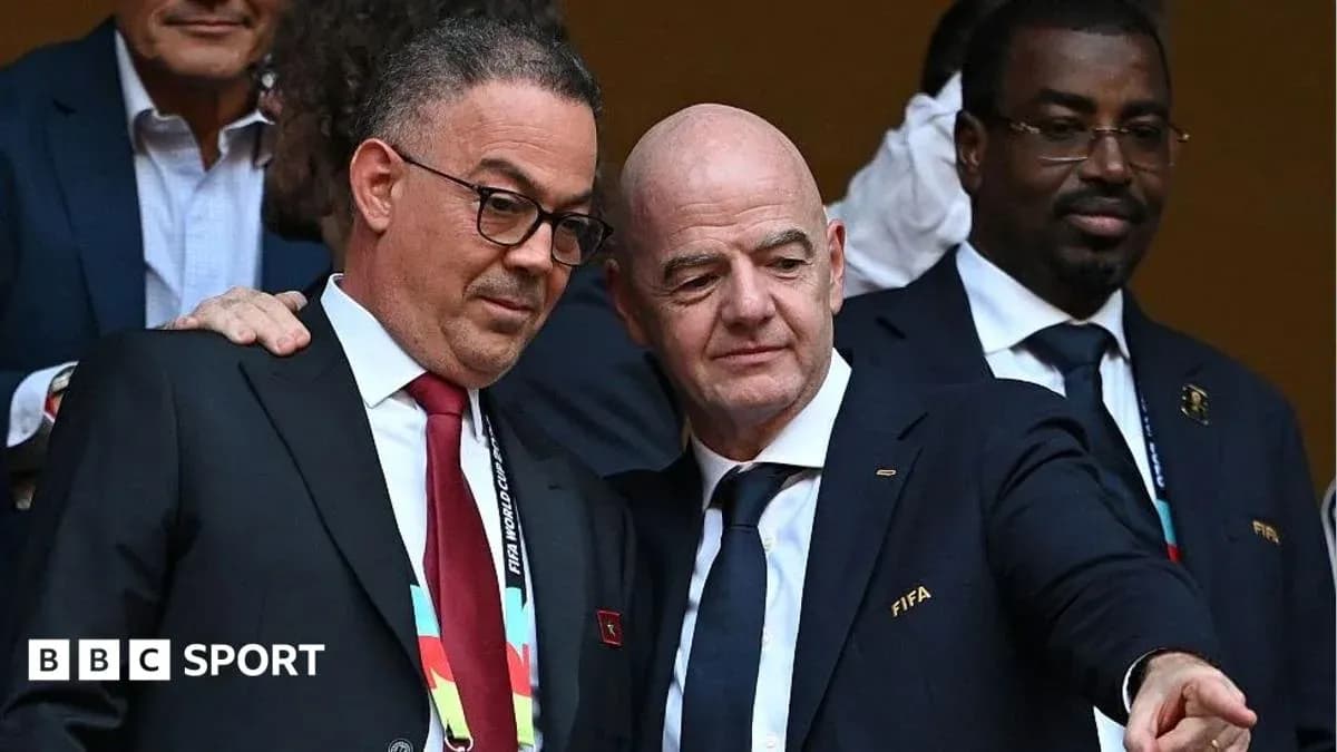 Two officials discussing at a FIFA event Two officials discussing at a FIFA event