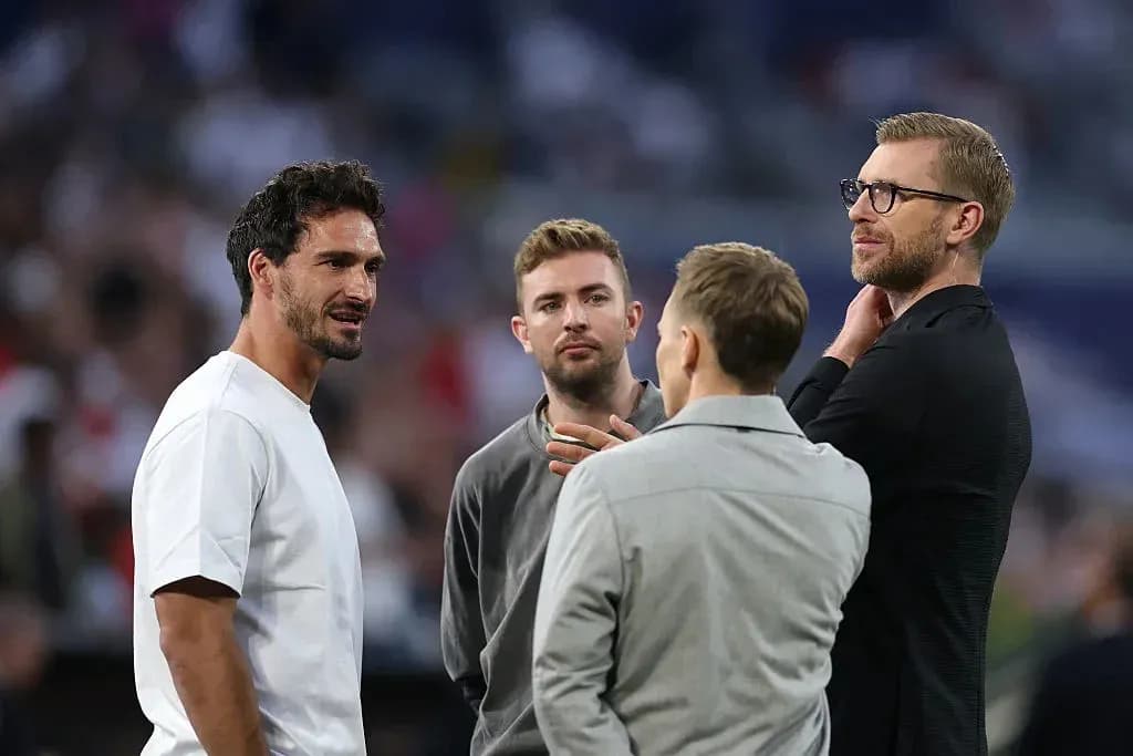 Four men talking on the pitch before the match Four men talking on the pitch before the match