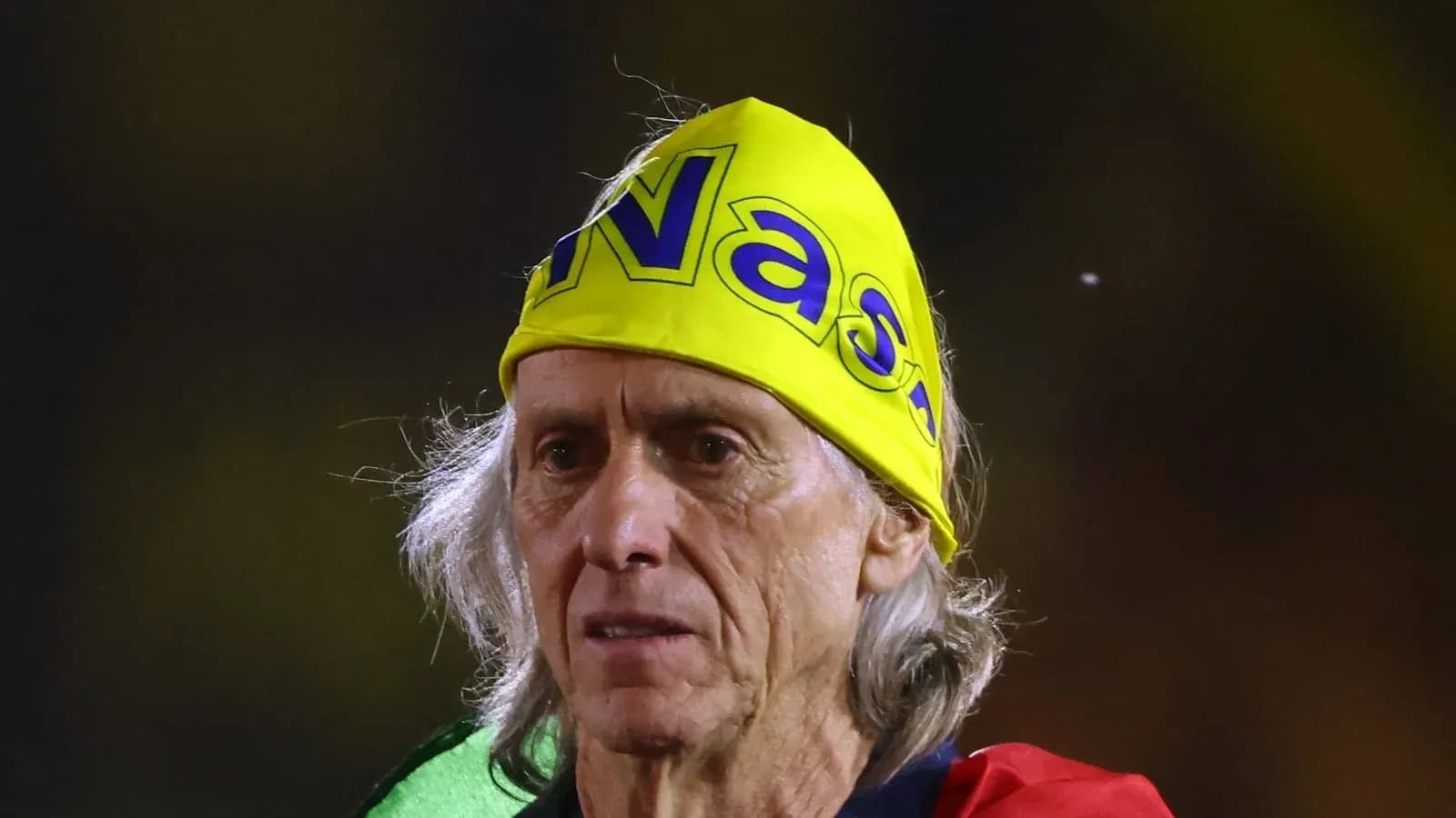Older man wearing a yellow bandana at event Older man wearing a yellow bandana at event