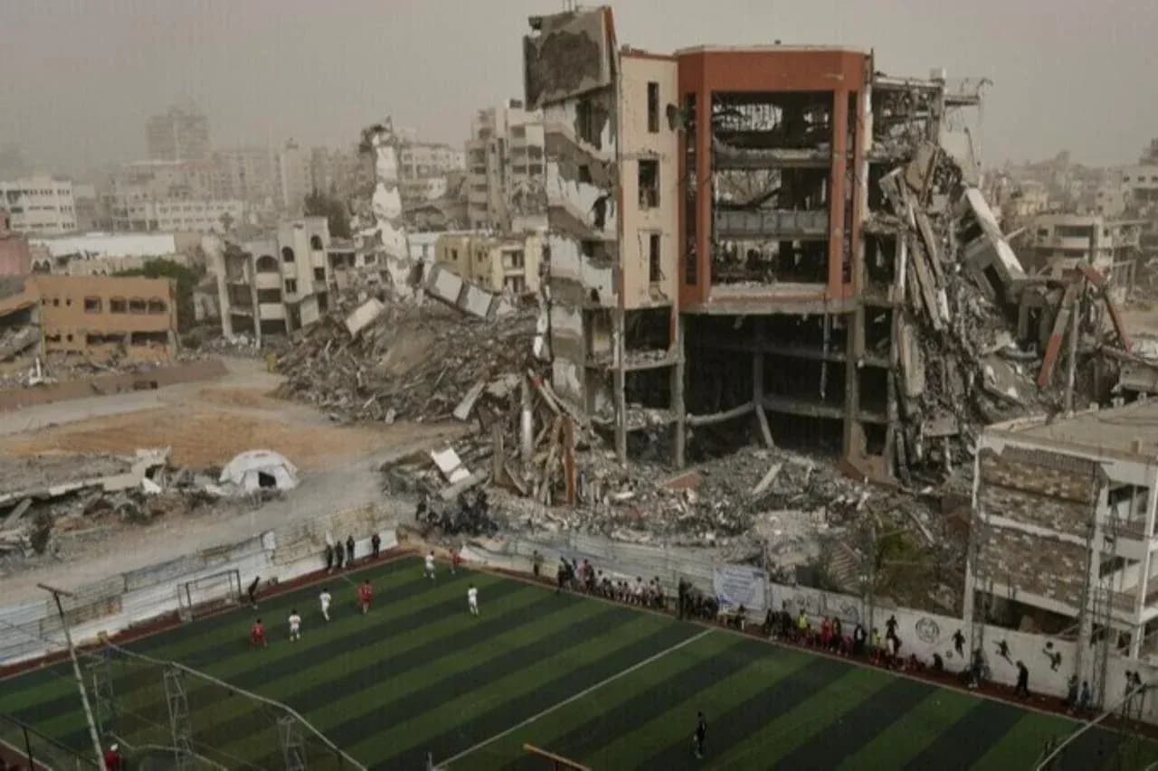 Football match in front of damaged buildings Football match in front of damaged buildings