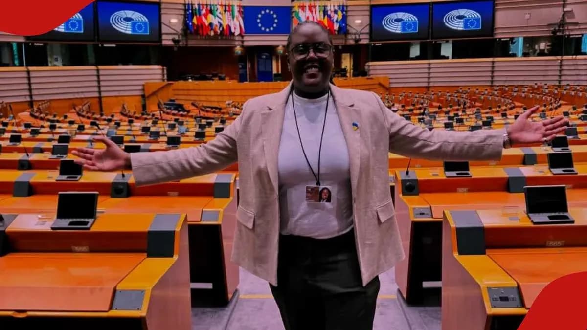 Woman standing in empty parliament chamber with arms outstretched Woman standing in empty parliament chamber with arms outstretched
