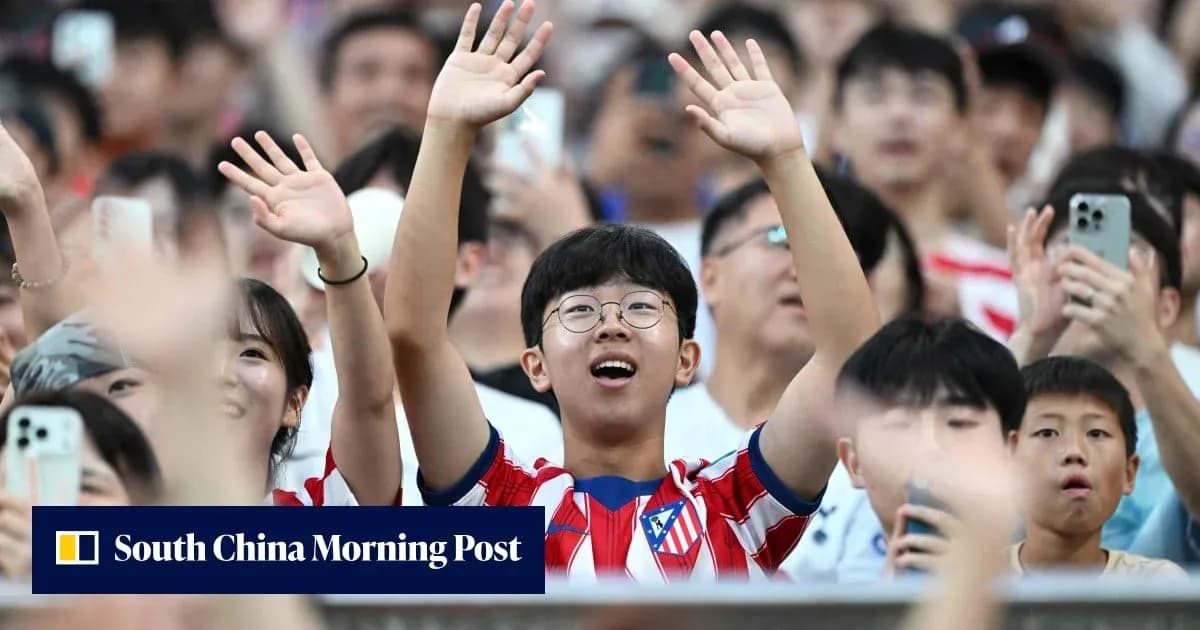 Young fan in Atlético Madrid jersey cheering in crowd Young fan in Atlético Madrid jersey cheering in crowd