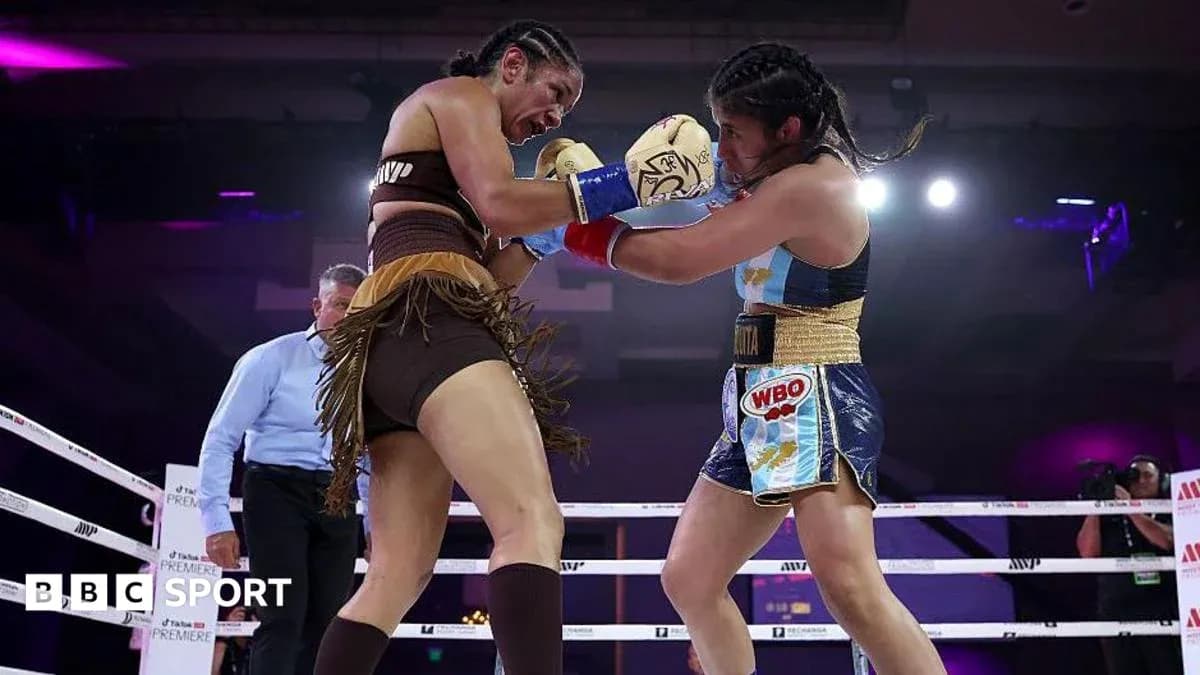 Two female boxers competing in the ring Two female boxers competing in the ring