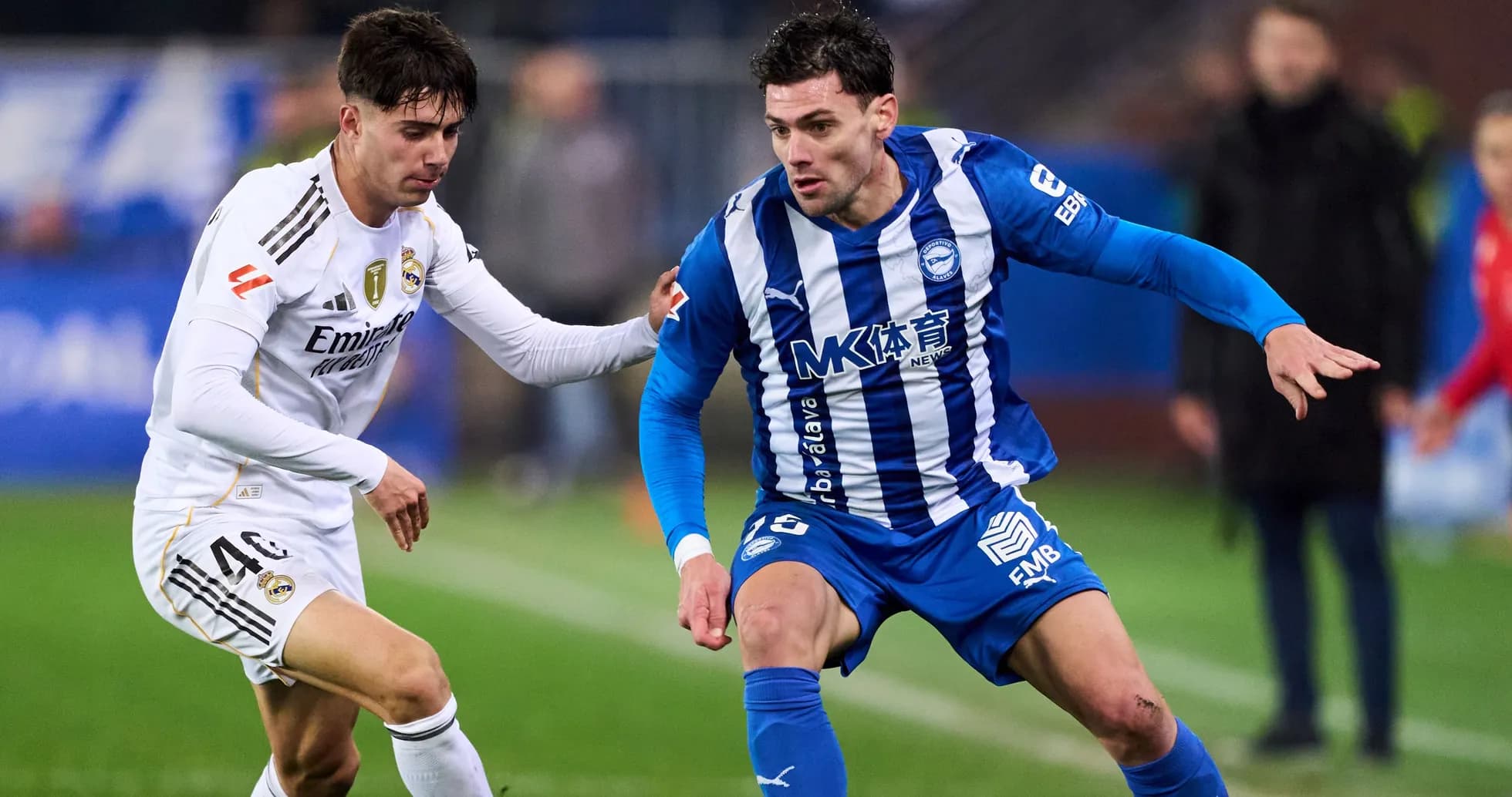 Two players competing for the ball on the field Two players competing for the ball on the field