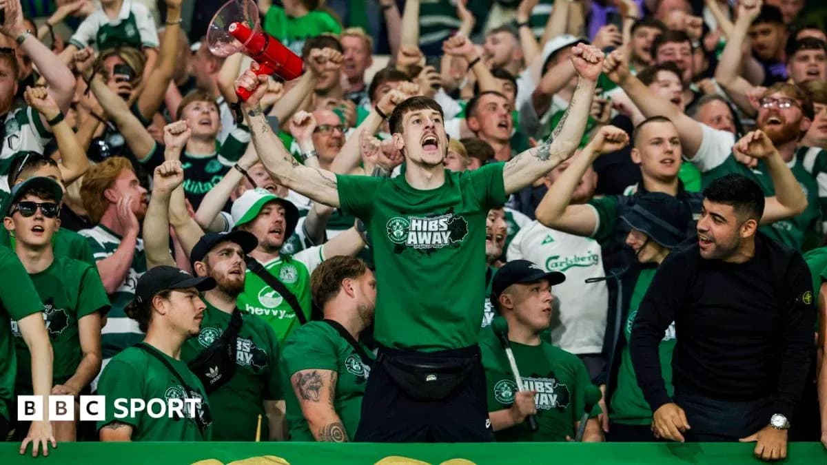 Hibernian fans cheering in the stands with a megaphone Hibernian fans cheering in the stands with a megaphone
