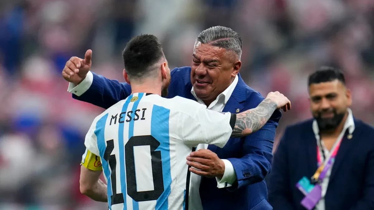 Lionel Messi embracing a man in formal attire Lionel Messi embracing a man in formal attire