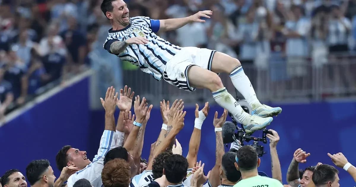 Messi being lifted by teammates after victory Messi being lifted by teammates after victory