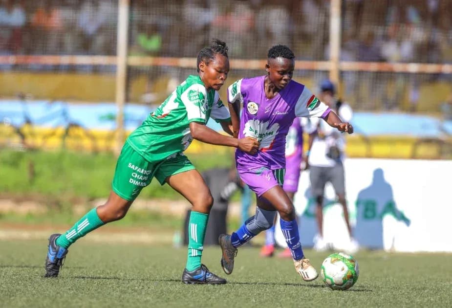 Two players competing for the ball on field Two players competing for the ball on field