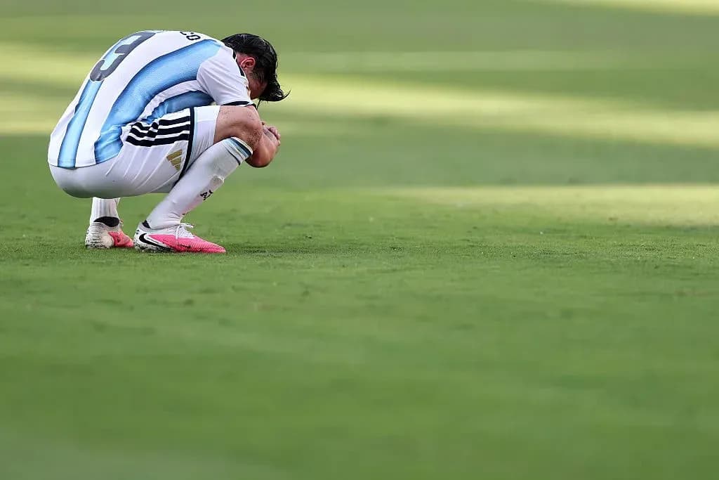 Futbolchi maydonda egilib o'tirgan holatda Futbolchi maydonda egilib o'tirgan holatda