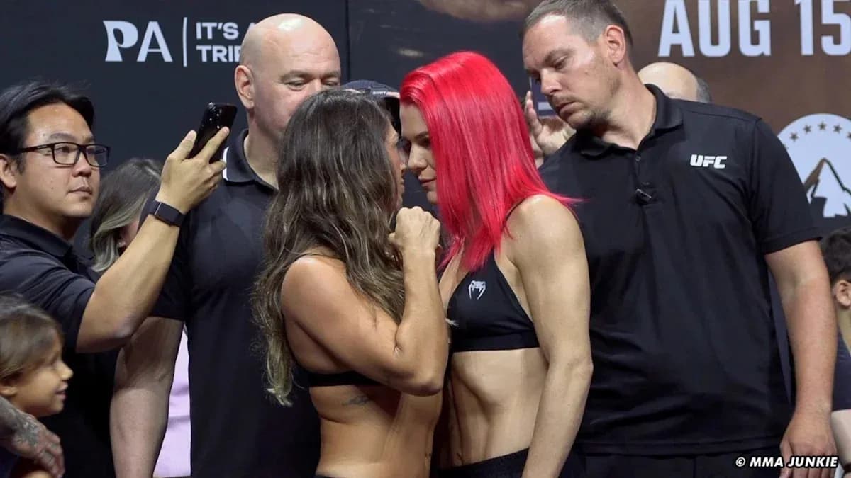 Two fighters facing each other during weigh-in event Two fighters facing each other during weigh-in event