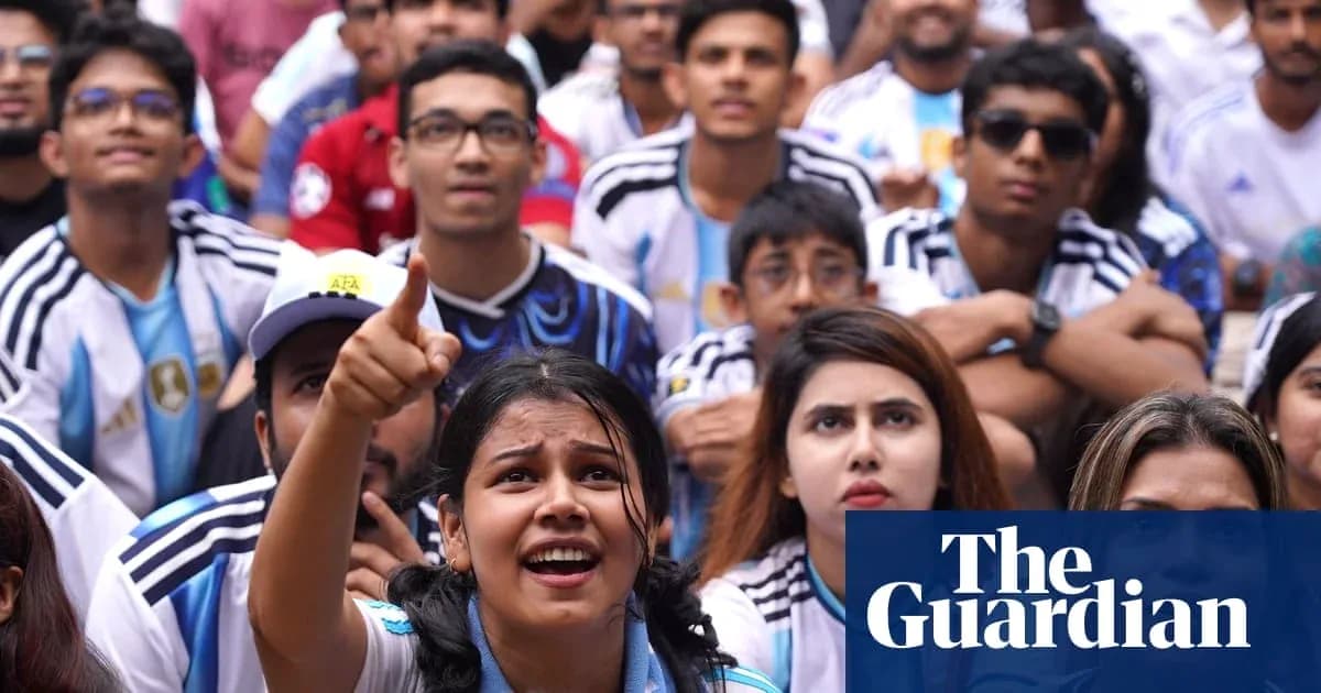 Fans watching football match, wearing Argentina jerseys Fans watching football match, wearing Argentina jerseys