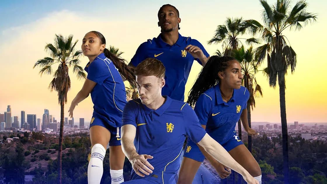 Four football players in blue kits posing outdoors Four football players in blue kits posing outdoors